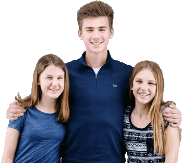 Three joyful teenagers share genuine smiles and warm embraces, radiating happiness and camaraderie