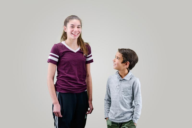 A girl and a boy are joyfully smiling