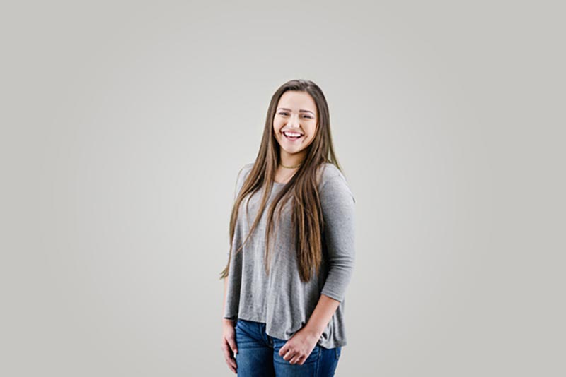 A teenage girl beams with a smile