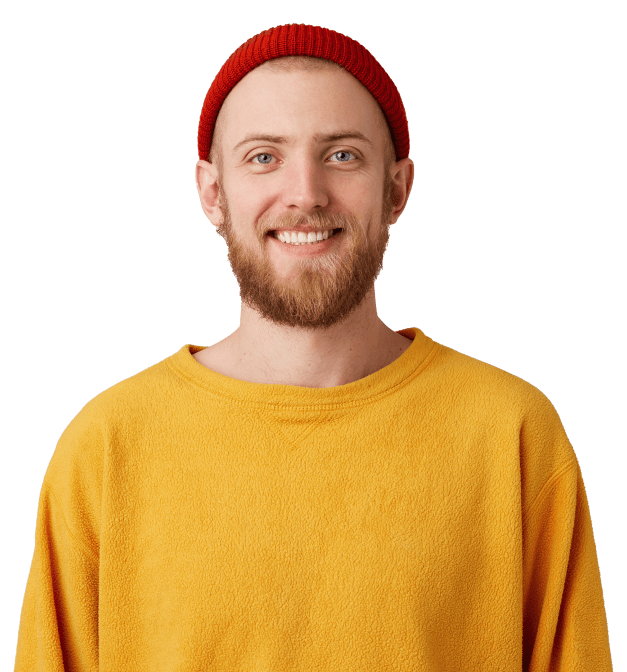 A man in a yellow sweater is happily smiling 